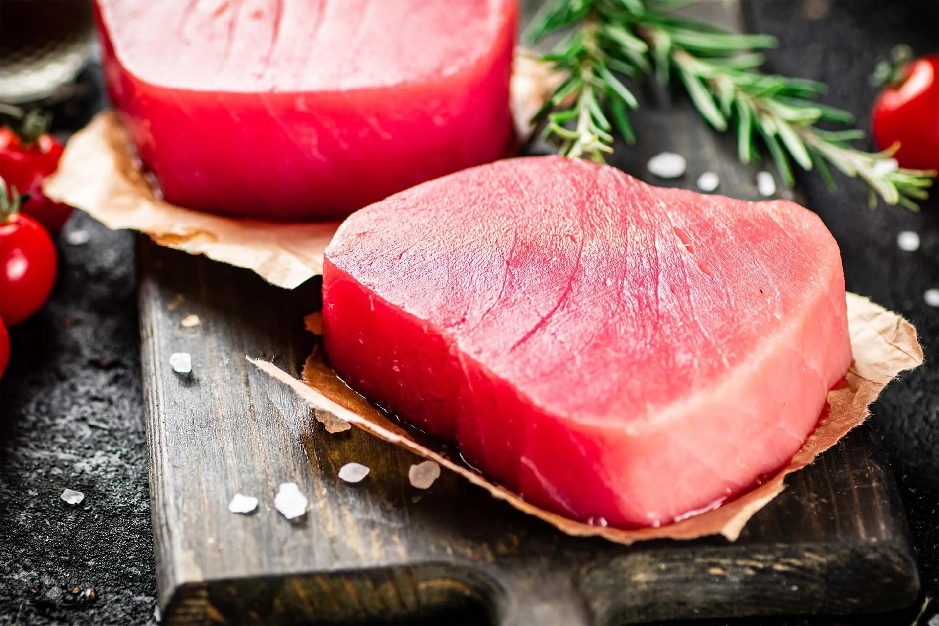 Premium tuna loin and raw shrimp on dark slate